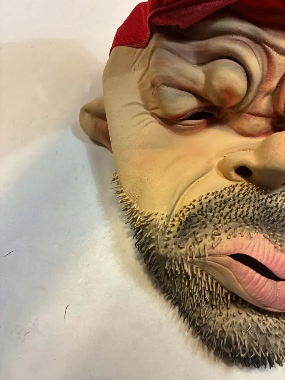 Realistic Man with Beard and Cigarette Latex Novelty Mask with Red Cap